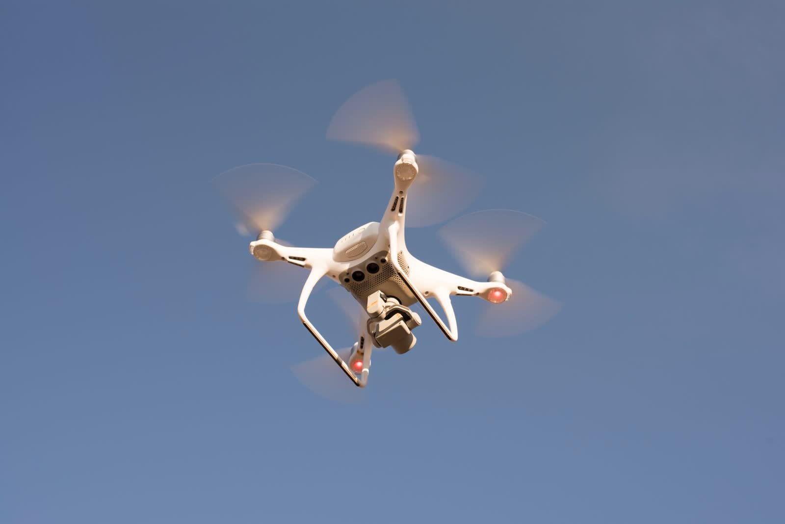 Drone flying against a blue sky